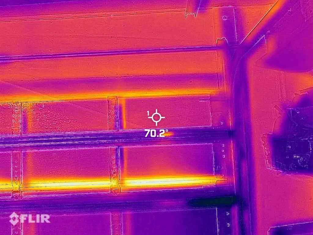 FLIR thermal image after weather seal replacement showing reduced heat infiltration above garage door